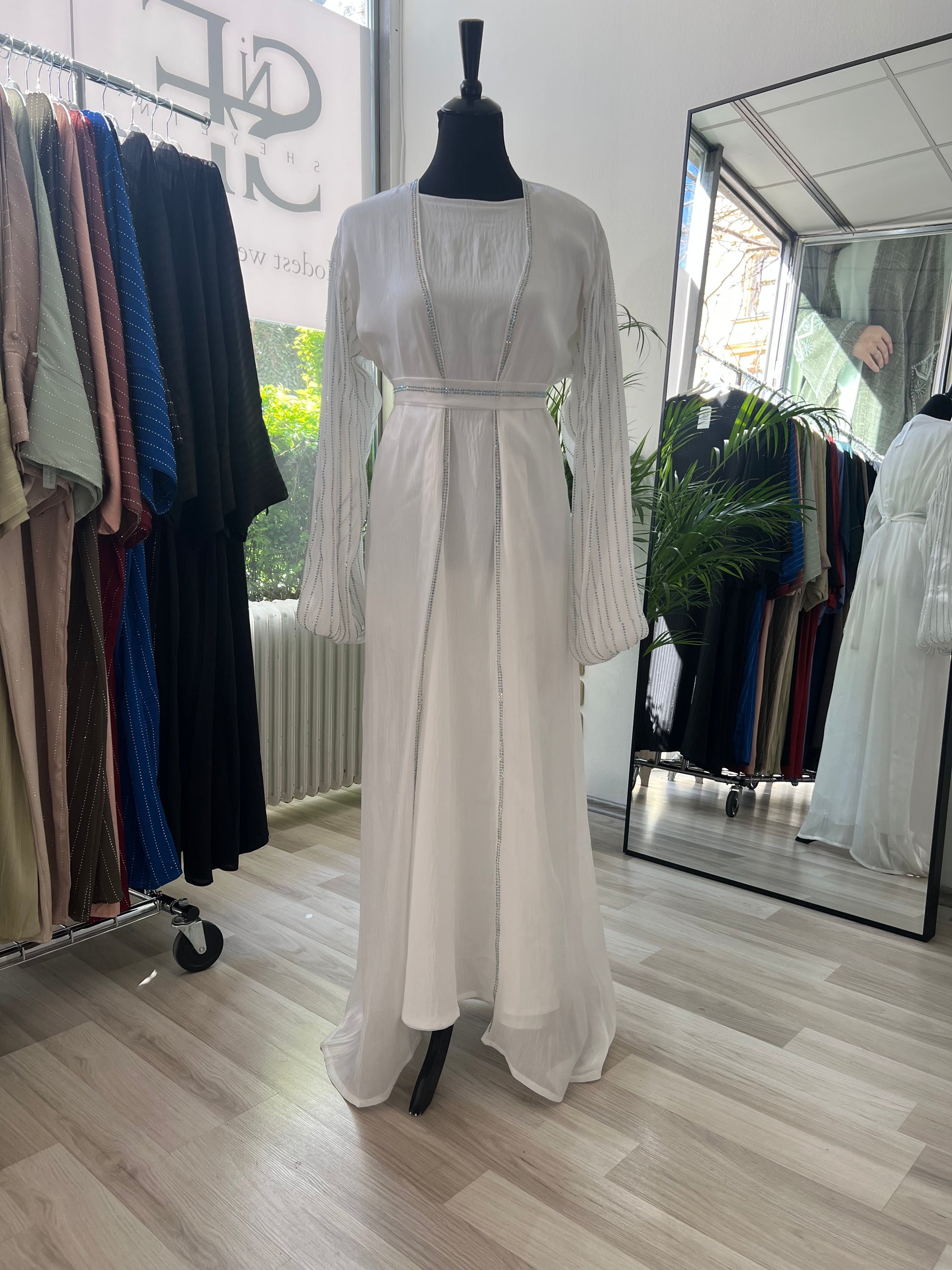 Weiße abaya auf der puppe mit kimono unterkleid weißes kopftuch
